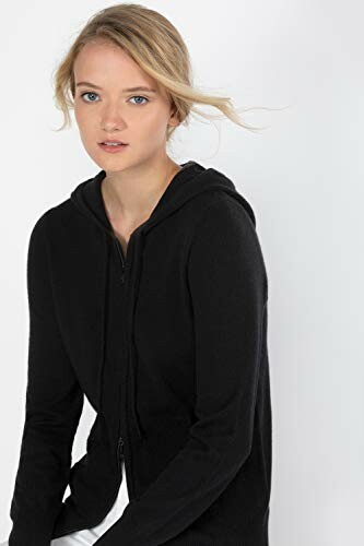 Woman in black hoodie looking at camera