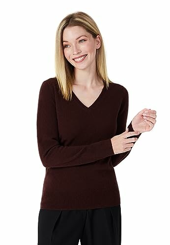 Woman in a brown V-neck sweater smiling