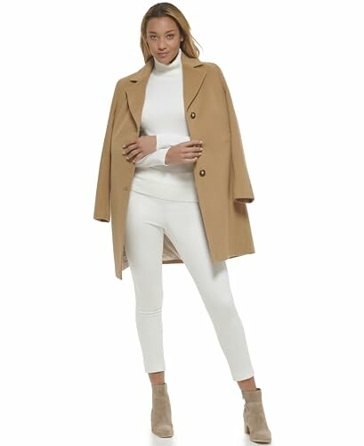 Woman in a camel coat and white outfit